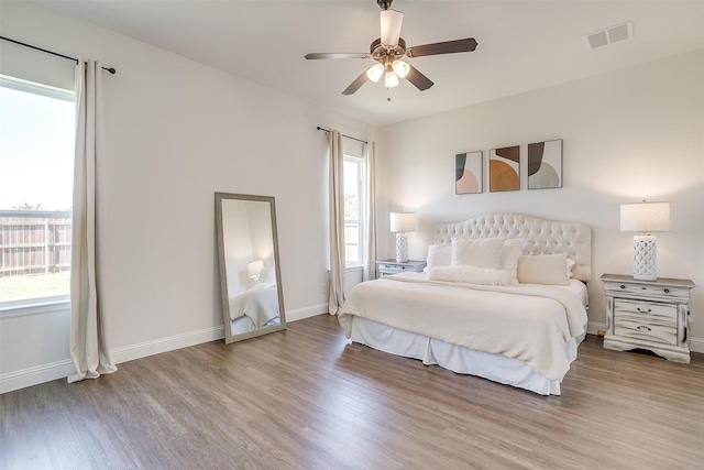 bedroom with ceiling fan and light hardwood / wood-style floors