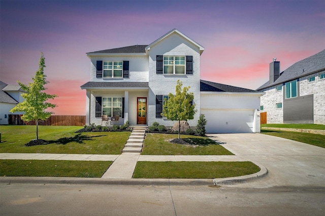 view of front of house featuring a lawn and a garage