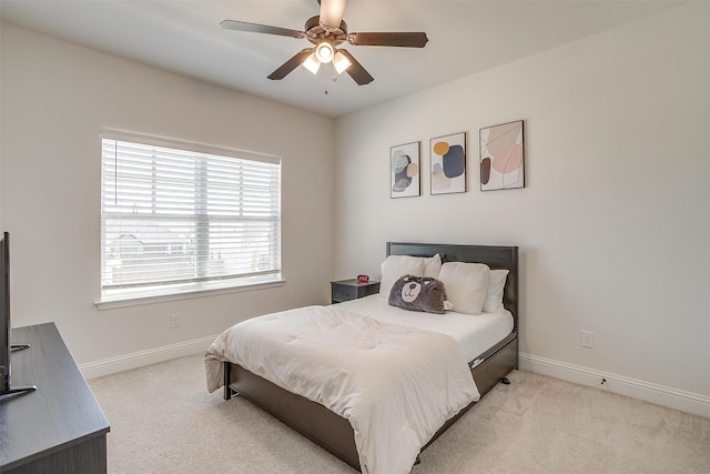 bedroom featuring ceiling fan and light colored carpet