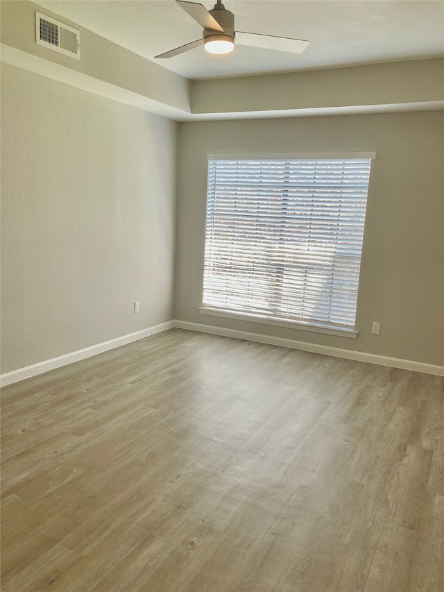 spare room featuring ceiling fan and light hardwood / wood-style floors