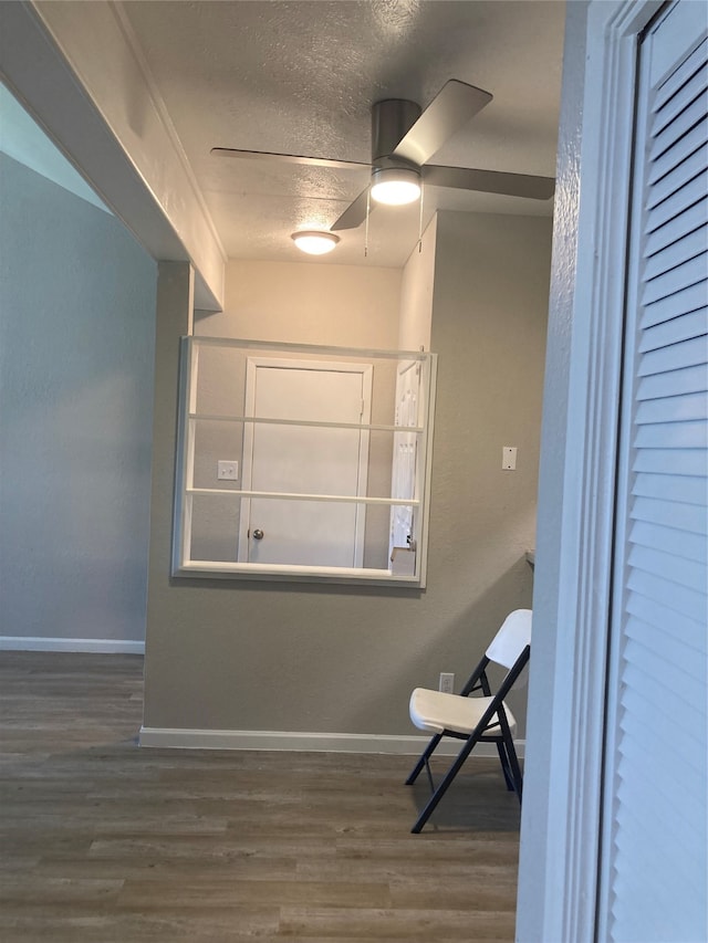 unfurnished room with a textured ceiling, hardwood / wood-style floors, and ceiling fan