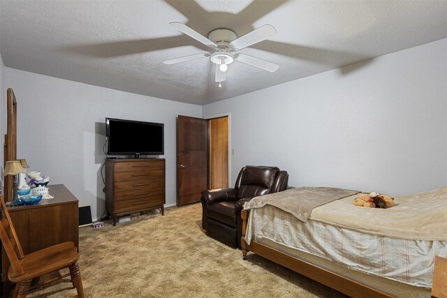 bedroom with ceiling fan, a textured ceiling, and light colored carpet