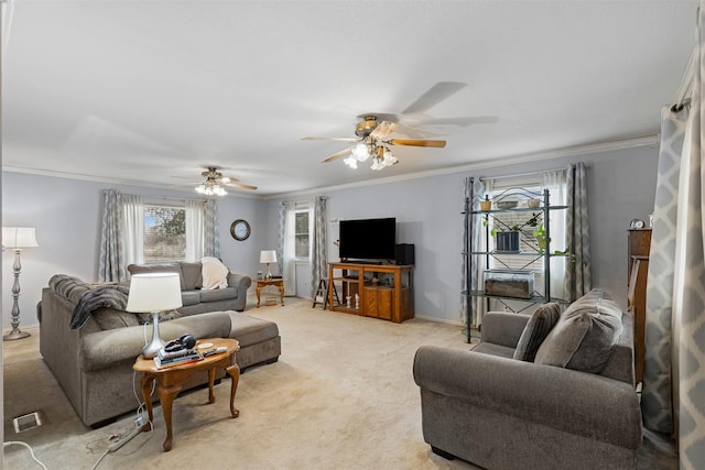 living area featuring baseboards, a ceiling fan, light colored carpet, and crown molding