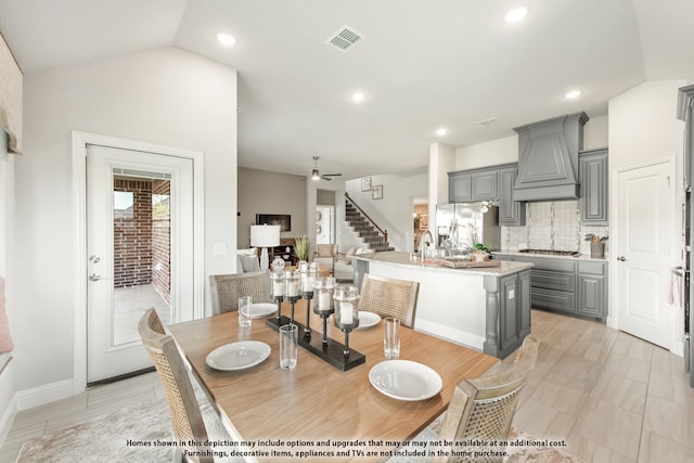 dining space featuring lofted ceiling and ceiling fan