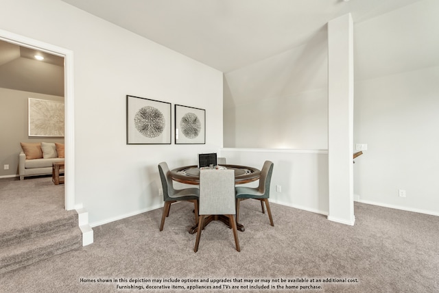 dining area featuring vaulted ceiling and light carpet