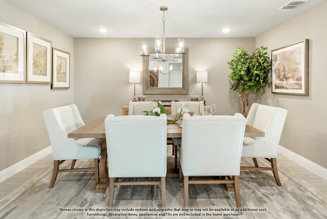 dining area featuring a chandelier and wood-type flooring