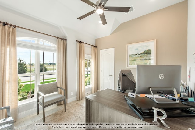 office space with ceiling fan, light tile patterned flooring, vaulted ceiling, and a wealth of natural light