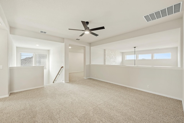 carpeted empty room featuring ceiling fan