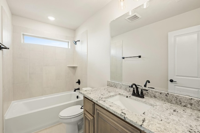 full bathroom featuring tiled shower / bath combo, vanity, and toilet