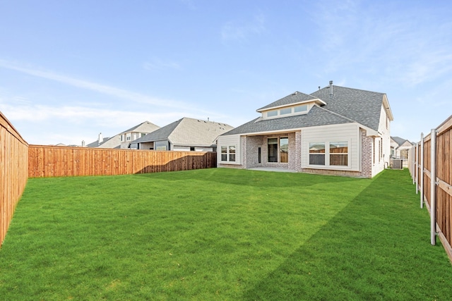 rear view of house featuring a yard