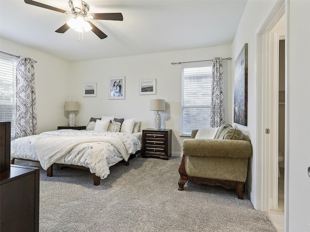 carpeted bedroom featuring multiple windows and ceiling fan