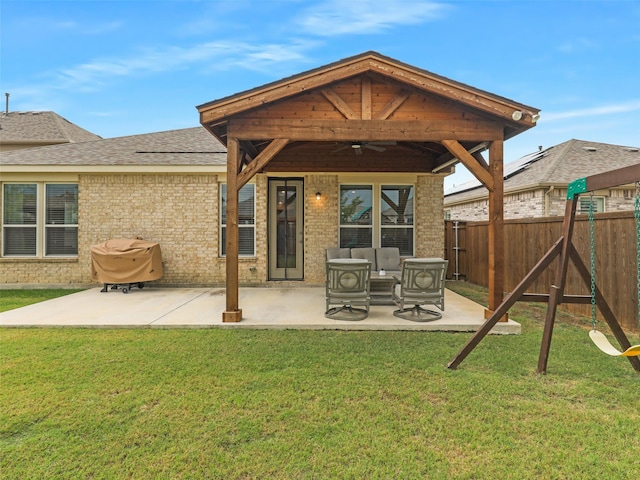 rear view of property with a patio, a lawn, and ceiling fan