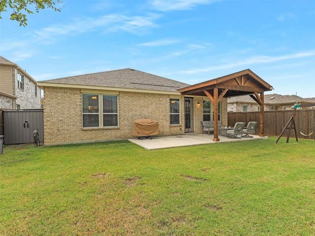 rear view of property with a yard and a patio