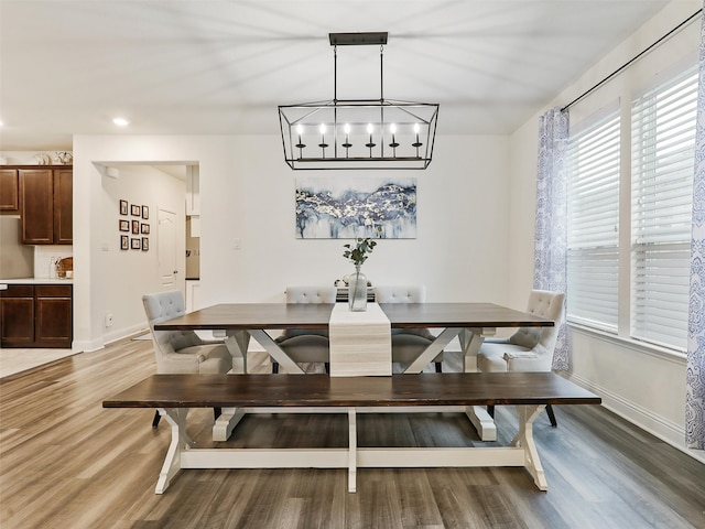 dining room featuring a wealth of natural light, hardwood / wood-style flooring, and an inviting chandelier