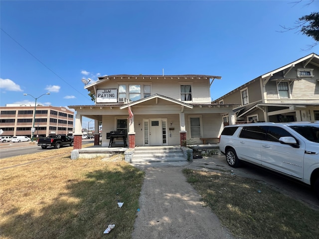 view of front of house featuring a porch and a front lawn