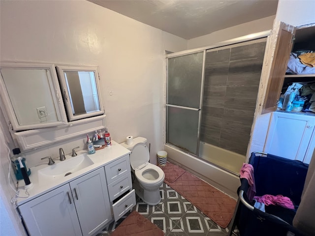 bathroom featuring vanity, toilet, and a shower with door