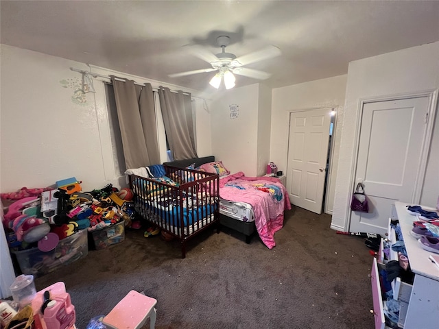 bedroom with ceiling fan and dark colored carpet