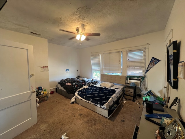 carpeted bedroom featuring cooling unit, ceiling fan, and a textured ceiling