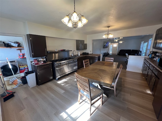 interior space with an inviting chandelier, sink, and light hardwood / wood-style floors