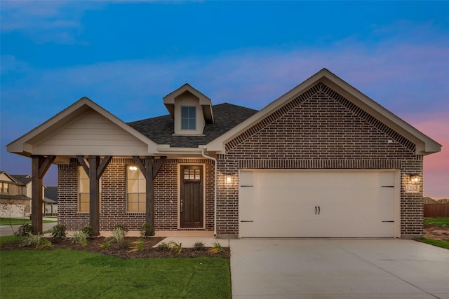 view of front of home featuring a garage and a lawn