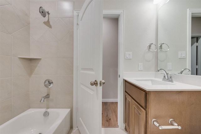 bathroom with vanity and tiled shower / bath combo