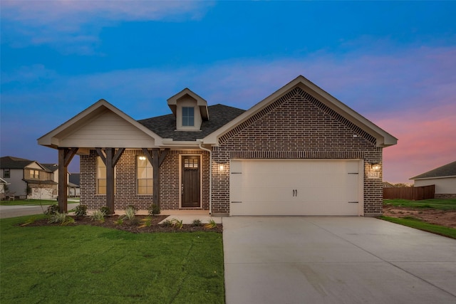 view of front of house featuring a lawn and a garage