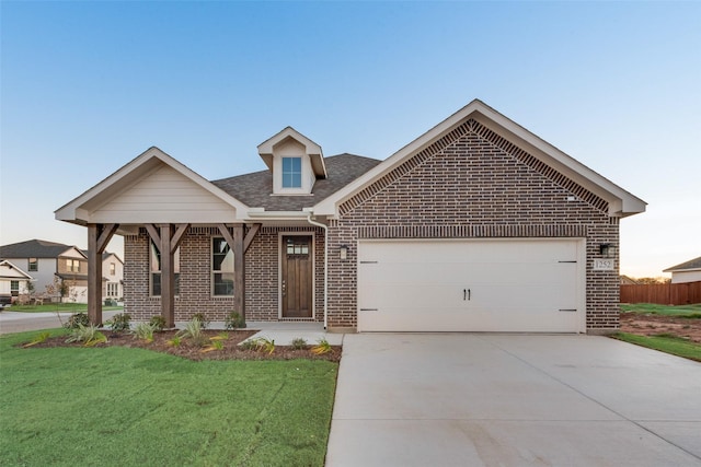 view of front of home with a garage and a front yard