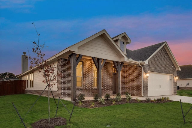 view of front of home with a garage and a yard