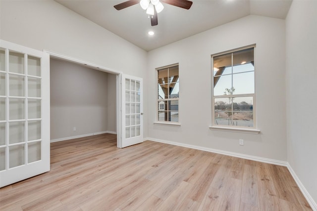 unfurnished room featuring vaulted ceiling, light hardwood / wood-style floors, french doors, and ceiling fan