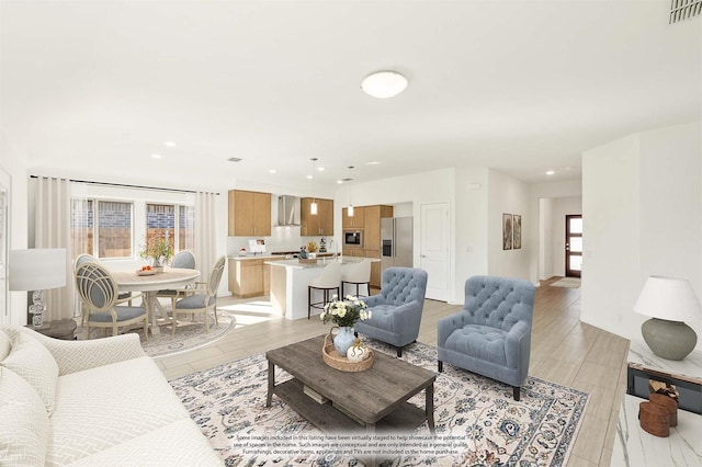 living room featuring sink and plenty of natural light