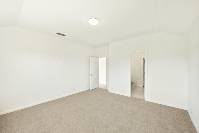 unfurnished room with vaulted ceiling and light colored carpet