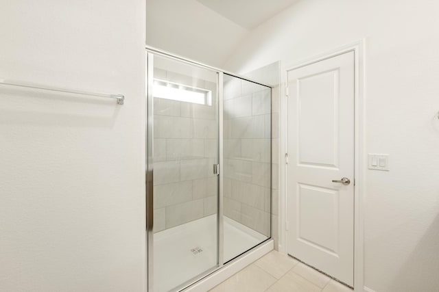 bathroom featuring tile patterned flooring and a shower with shower door