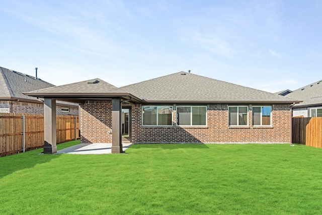 rear view of house featuring a patio area and a lawn