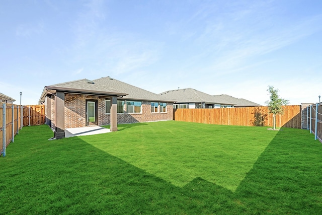 back of property featuring a patio and a yard