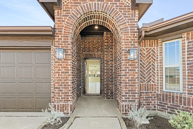 view of exterior entry with a garage