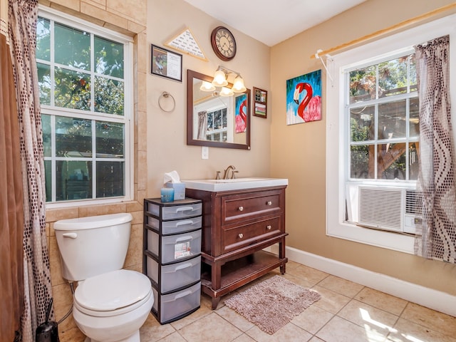 bathroom with vanity, toilet, tile patterned floors, and a notable chandelier