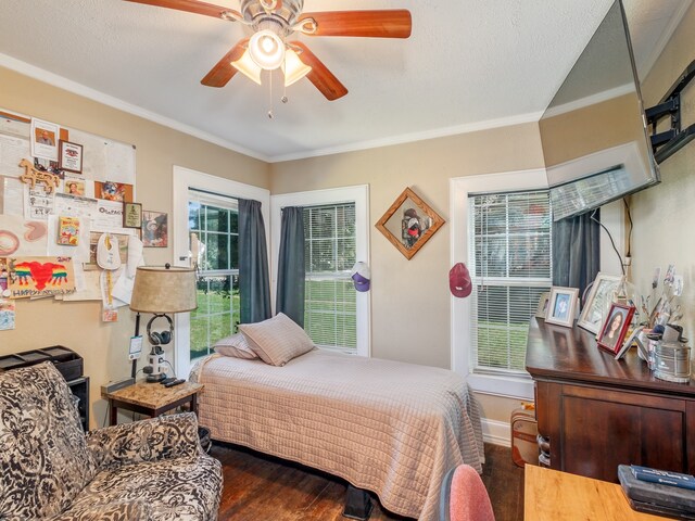 bedroom with dark wood-type flooring, multiple windows, and ceiling fan