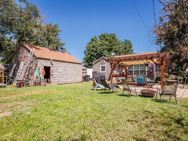 view of yard featuring an outdoor fire pit and a pergola