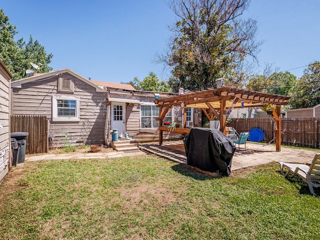 back of house featuring a pergola, a lawn, and a patio