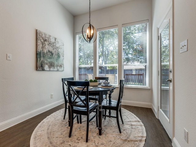 dining area featuring an inviting chandelier and dark hardwood / wood-style flooring