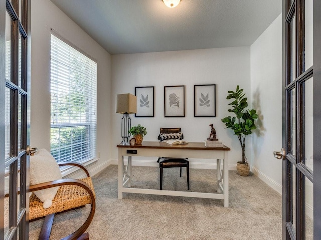 office featuring french doors and light carpet