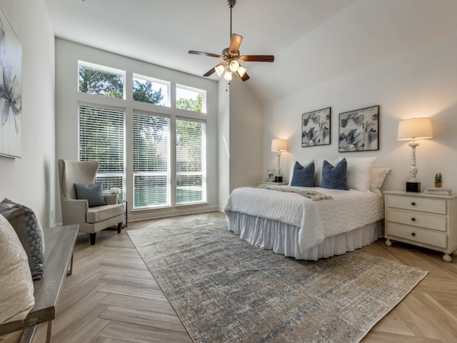 bedroom featuring a towering ceiling, light parquet floors, and ceiling fan