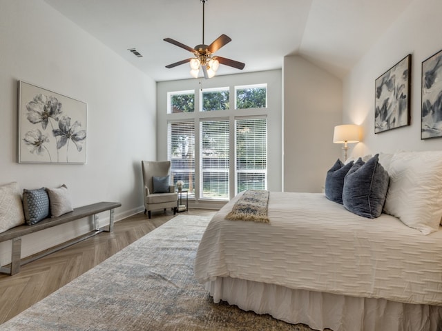 bedroom featuring ceiling fan, vaulted ceiling, and parquet floors