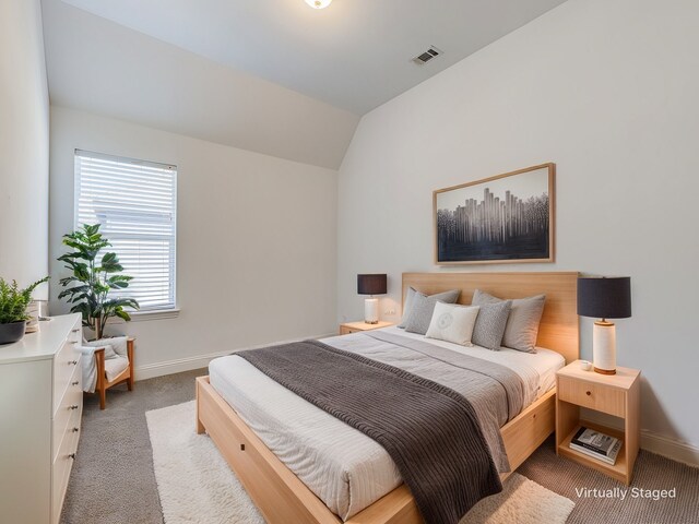 carpeted bedroom with vaulted ceiling