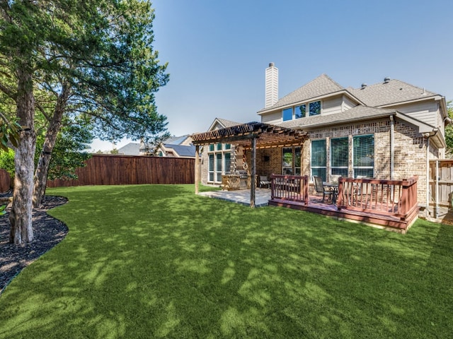 back of property featuring a patio, a yard, a pergola, and a wooden deck