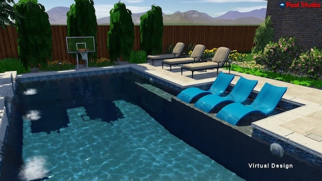 view of swimming pool with a patio and a mountain view