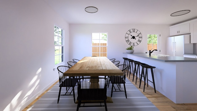 dining area with dark wood-type flooring and sink