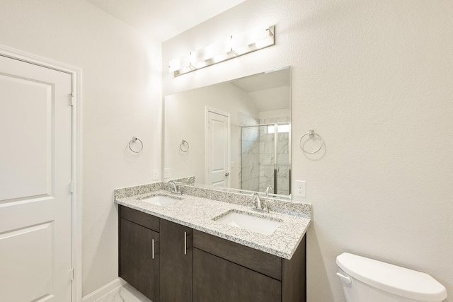 bathroom with vanity, toilet, and an enclosed shower