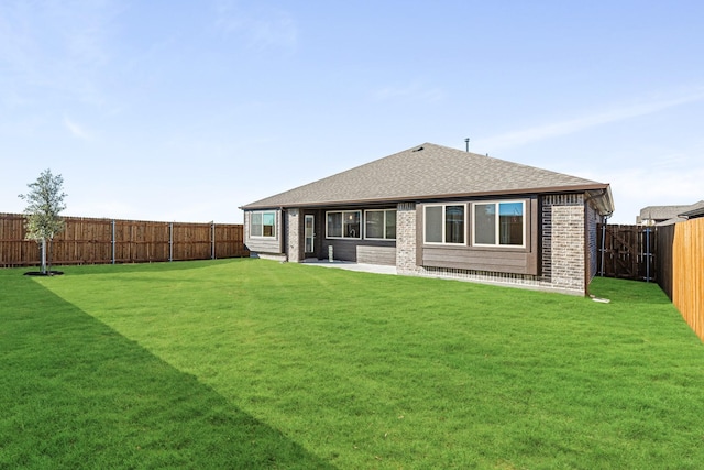 rear view of house featuring a yard