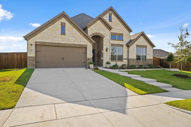 view of front of house with a garage and a front lawn